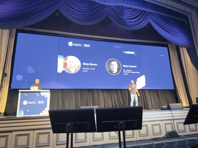 A stage screen showing Shay Banon and Bahs Azarmi at an Elastic event.