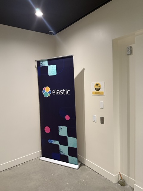 An Elastic banner inside an event venue hallway.