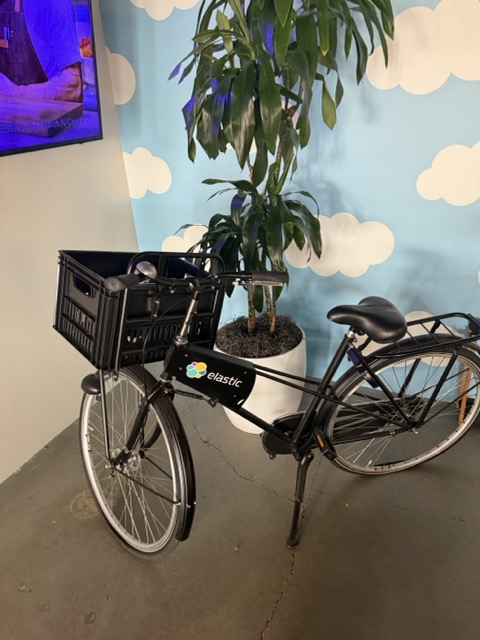 A bicycle with Elastic branding in an office space.