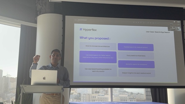 BK Bhate gesturing while presenting a proposed Elastic-based solution.