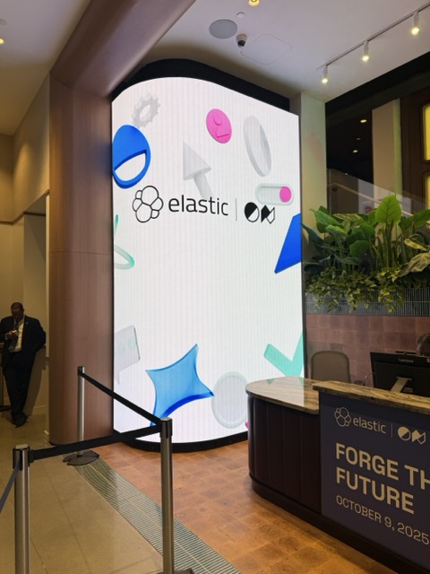 A large Elastic display and event desk inside a venue.